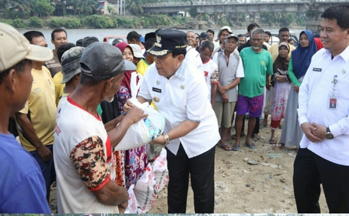 Bupati dan Ketua K3S Rohul Bagikan Ratusan Paket Sembako‎ ke Penambang Pasir di Ujung Batu